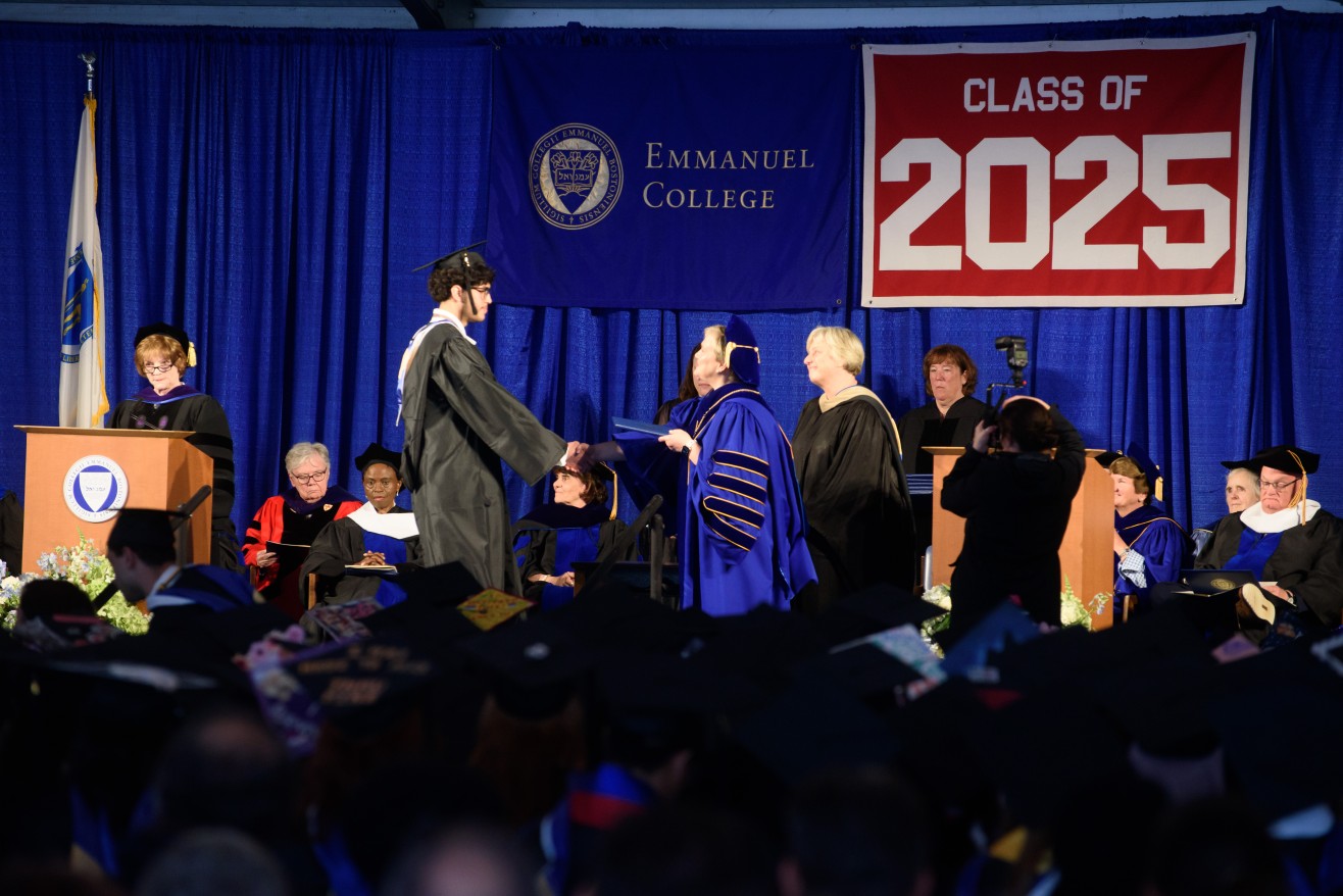 Student receives his diploma onstage